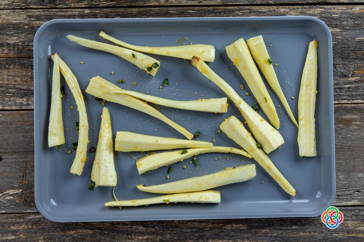 Peeled and sliced parsnips on a baking tray | Irish American Mom Sliced parsnips on a baking sheet