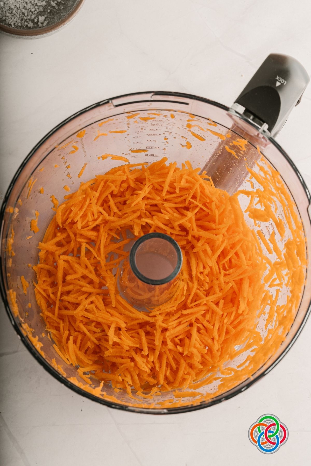 Shredded carrots in a food processor for homemade vegan vegetable stock cubes | Irish American Mom Shredded carrots in a food processor