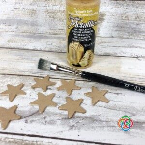 Golden stars with a paintbrush and bottle of gold paint