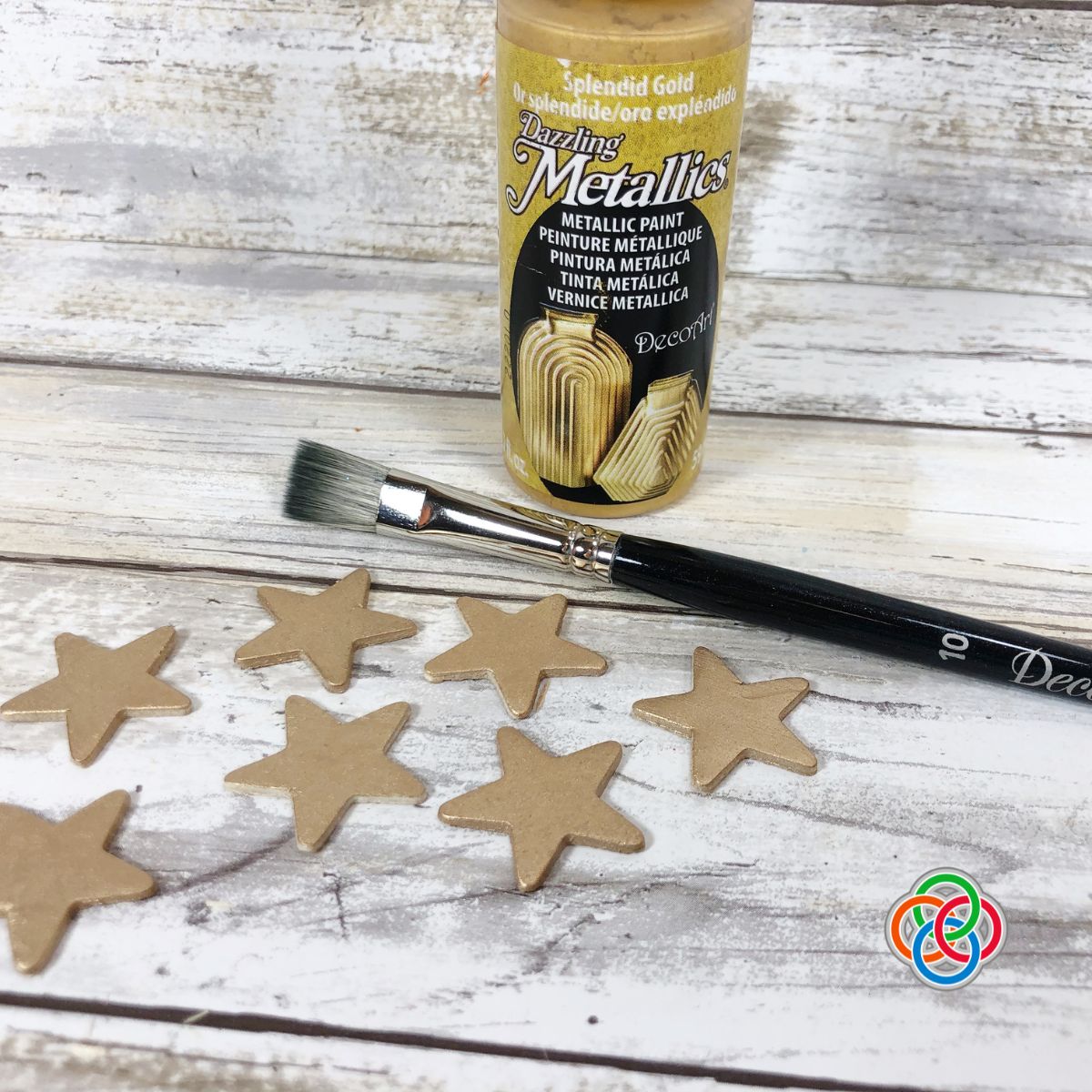 Painting a wooden star for a sewing spool Christmas tree or | Irish American Mom Golden stars with a paintbrush and bottle of gold paint
