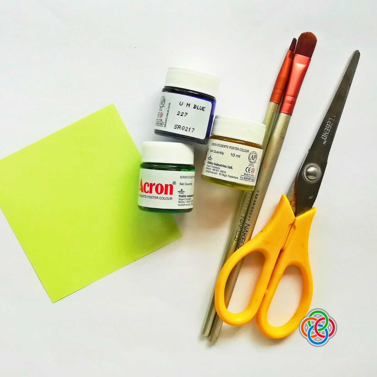 Scissors, paint brush, paint and paper