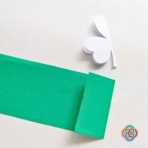 Green paper strip and paper shamrock folded in half