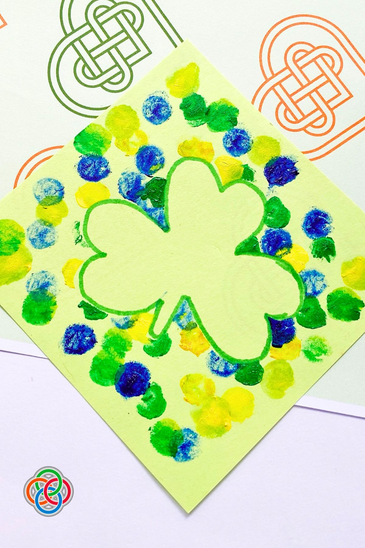 Splatter paint shamrock art piece with text banner
