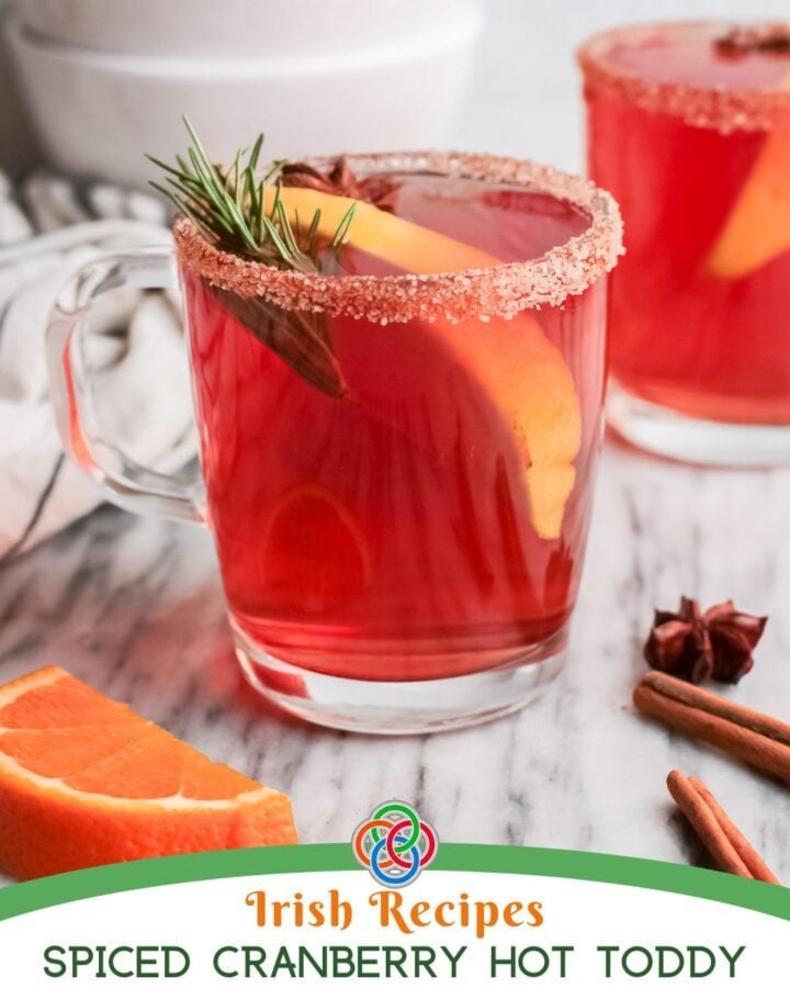 Cranberry hot toddy in a glass with text banner