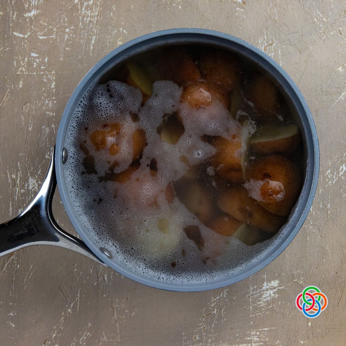 Cooking potatoes for potato salad recipe | Irish American Mom Potatoes simmering in a pot
