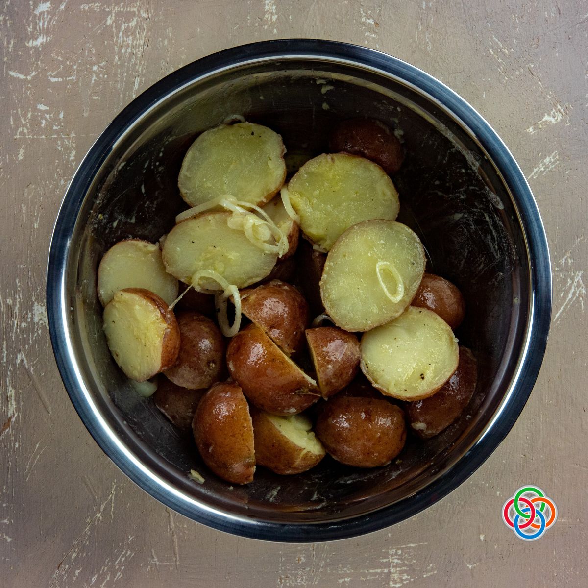 Coolingpotatoes for potato salad recipe | Irish American Mom Sliced cooked potatoes in a bowl