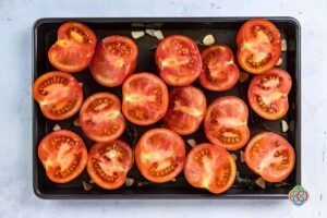 Halved tomatoes on a baking tray