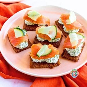 Smoked salmon and cream cheese cracker appetizers on a plate