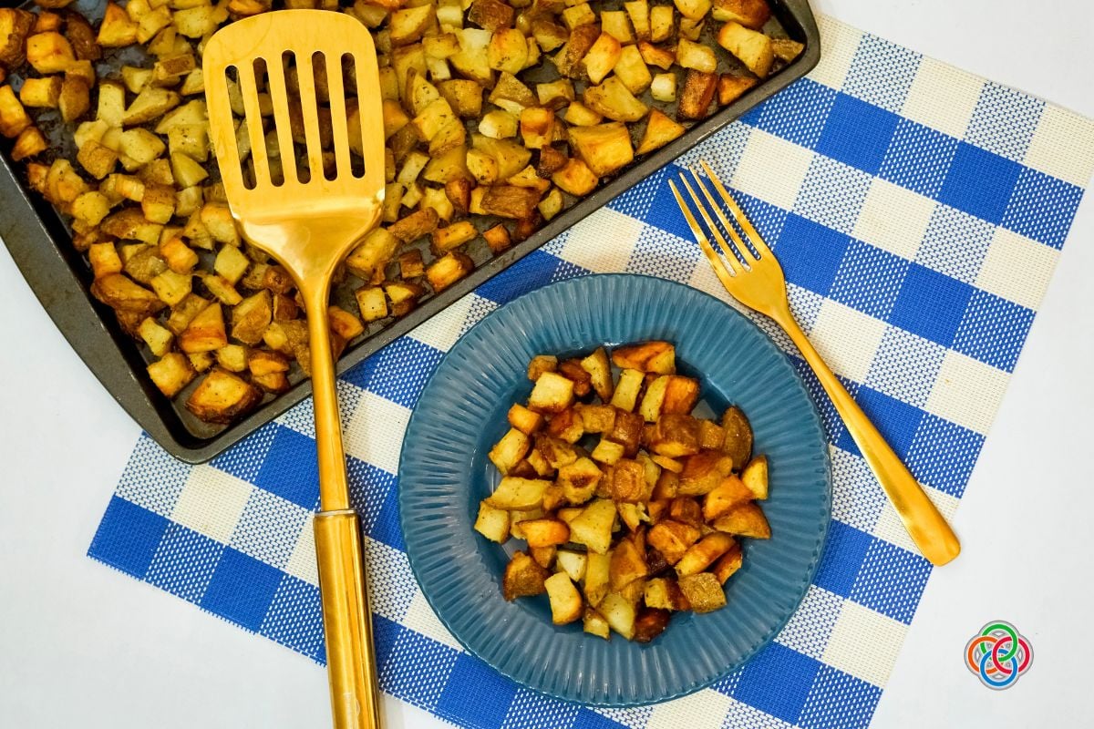 Roasted potatoes on a plate and sheetpan