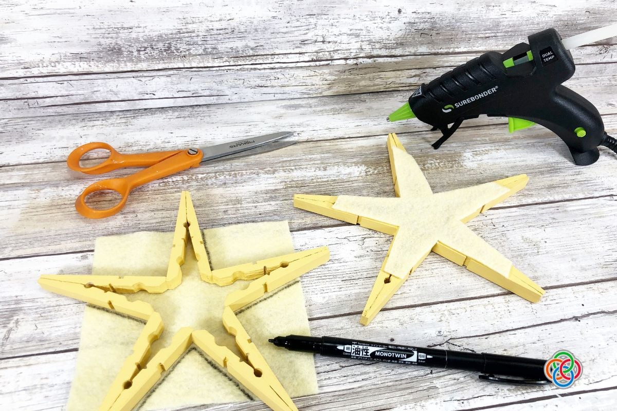 Assembling a Christmas star using clothespins