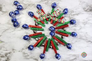 Advent Christmas wreath made from clothespins with chocolate treats attached