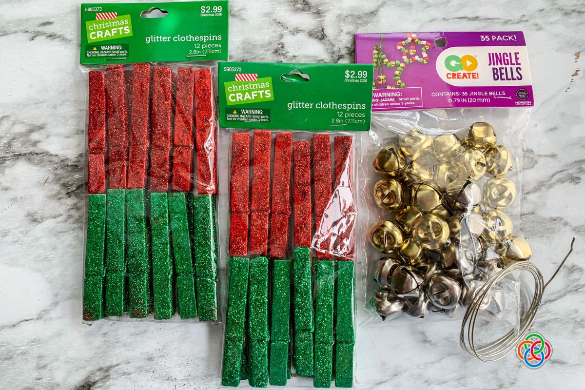 Two bags of glitter crafthing clothespins and a bag of craft bells