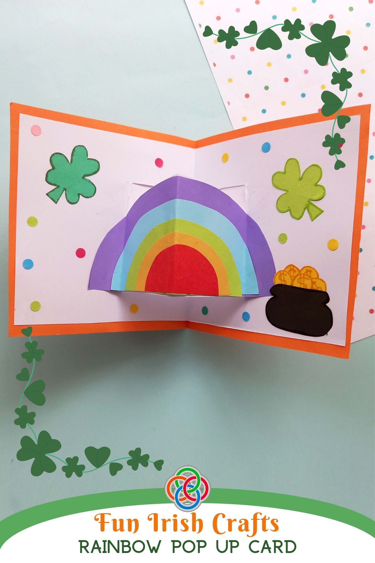 Fun Irish Crafts Rainbow Pop Up Card | Irish American Mom Pinterest graphic featuring a Saint Patrick’s Day rainbow pop up card with shamrocks and a pot of gold, titled “Fun Irish Crafts Rainbow Pop Up Card.”