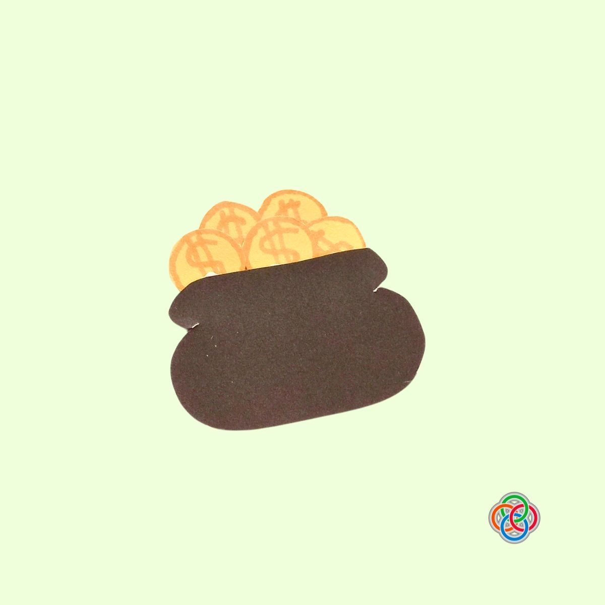 Glue coins on top of the pot for Pop Up Rainbow Card Craft | Irish American Mom Brown paper pot with yellow coins glued on top, creating a pot of gold for a Saint Patrick’s Day pop up rainbow card craft.