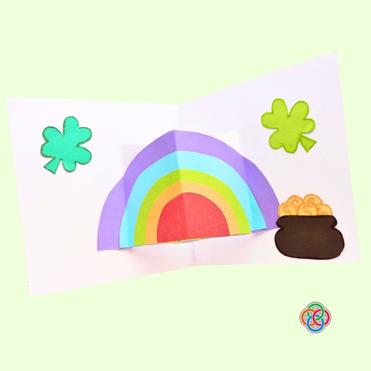 Glue the shamrock leaves inside the card for Pop Up Rainbow Card Craft | Irish American Mom