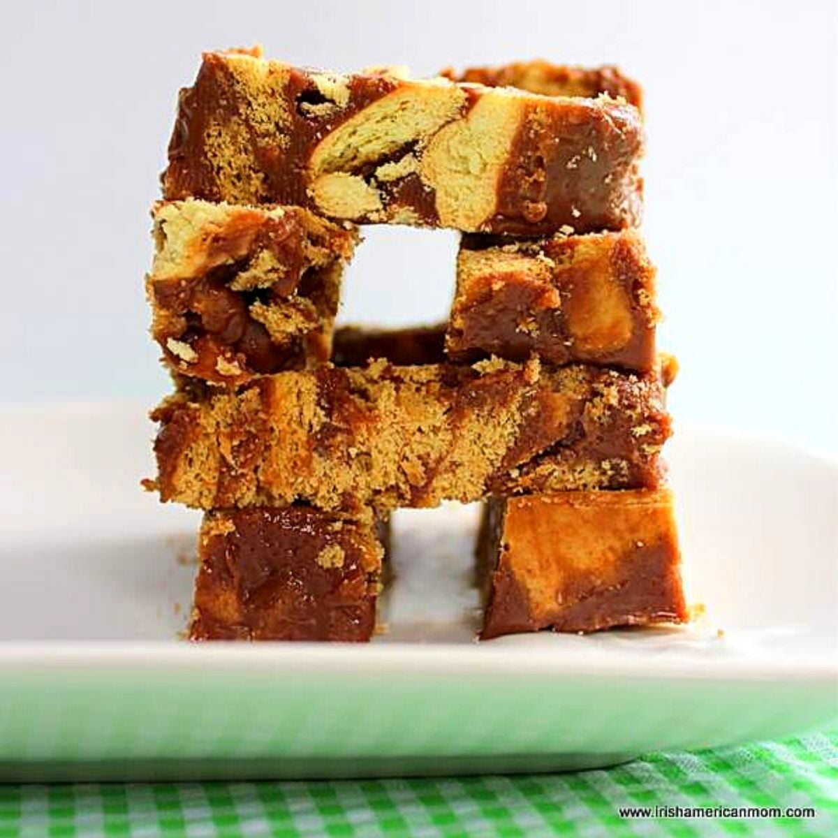 Slices of chocolate biscuit cake stacked to show crunchy biscuit texture inside.