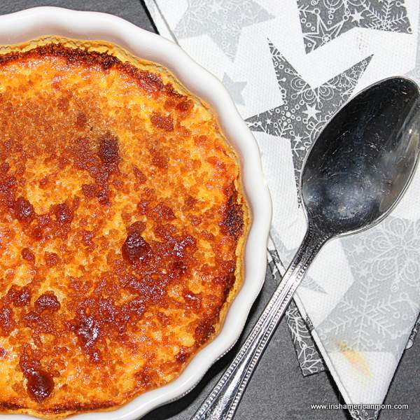 Baileys crème brûlée with caramelized sugar top and a spoon.