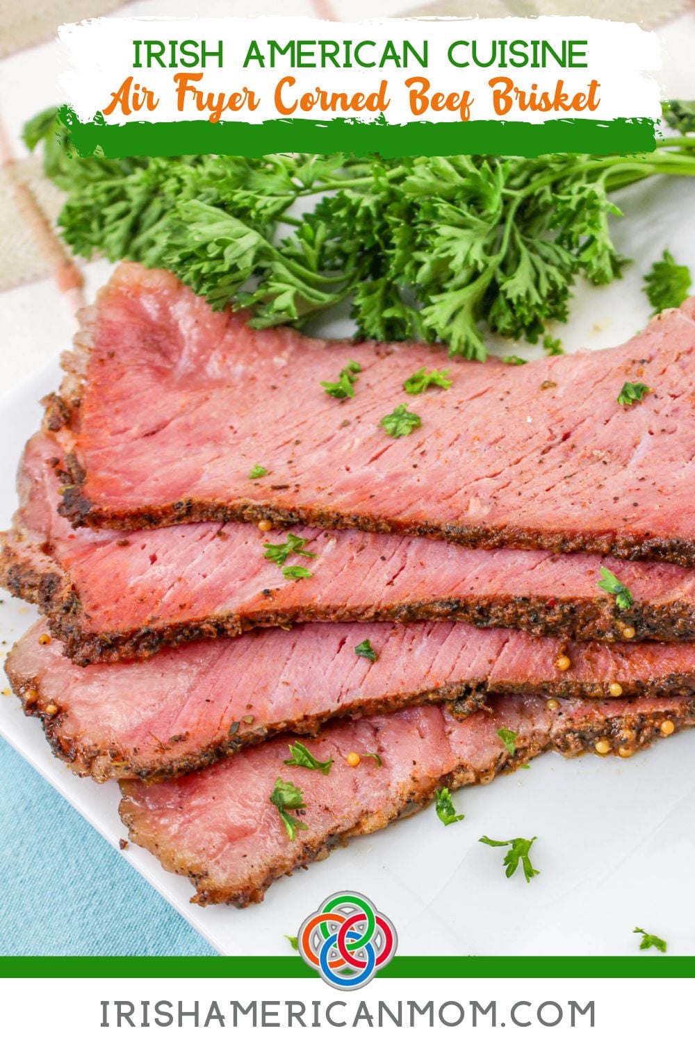 Slices of seasoned air fryer corned beef brisket on a white plate garnished with parsley with text overlay reading “Irish American Cuisine Air Fryer Corned Beef Brisket.”