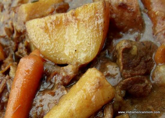 Bowl of Irish Guinness beef stew with tender beef, potatoes, and carrots in a rich dark gravy.