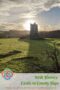 Historic medieval tower house castle ruin in County Sligo, Ireland, standing on a grassy hill at sunset with sunlight glowing behind the stone tower.