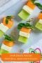 Top-down view of Irish flag appetizer stacks made with honeydew, feta cheese, and cantaloupe topped with mint and cocktail picks on a white platter, with text overlay reading “Irish Party Recipe Irish Flag Appetizer Stacks.”