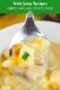 Close-up of a spoonful of creamy cheesy ham and potato soup with chunks of potato and ham, topped with melted cheddar and green onions, with text reading Irish Soup Recipes Cheesy Ham and Potato Soup.