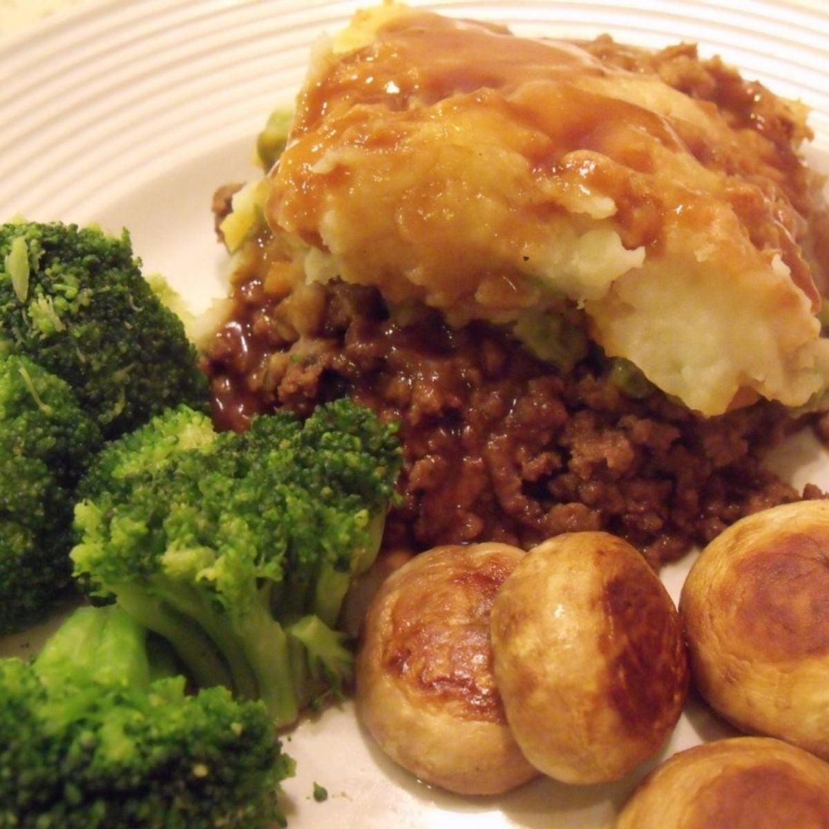 Shepherd’s pie with mashed potato topping served with broccoli and mushrooms.