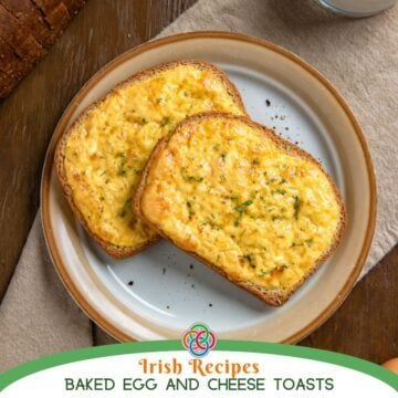 Two slices of Irish baked egg and cheese toasts on a plate, topped with a golden cheesy egg mixture and garnished with herbs, served on a rustic wooden table.