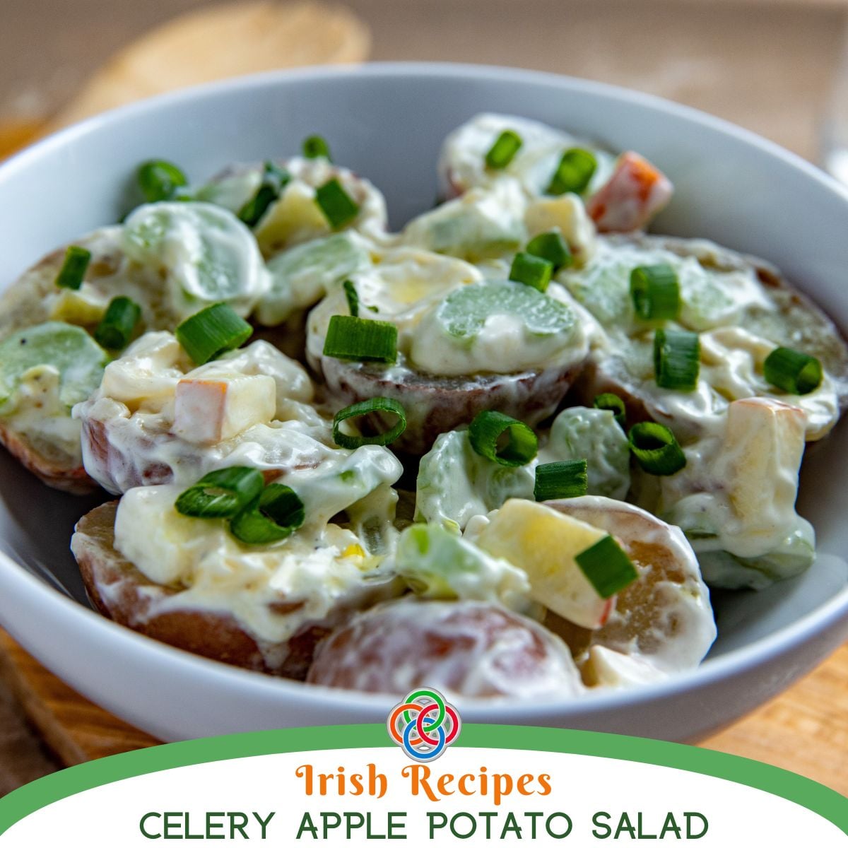 Potato salad with chopped apples and celery for added crunch over a text banner.