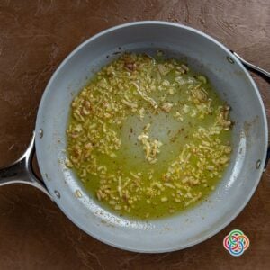 Cookin shallots in a skillet | Irish American Mom Finely chopped shallots sautéing in butter and oil in a skillet, forming the base for Irish pork gravy.