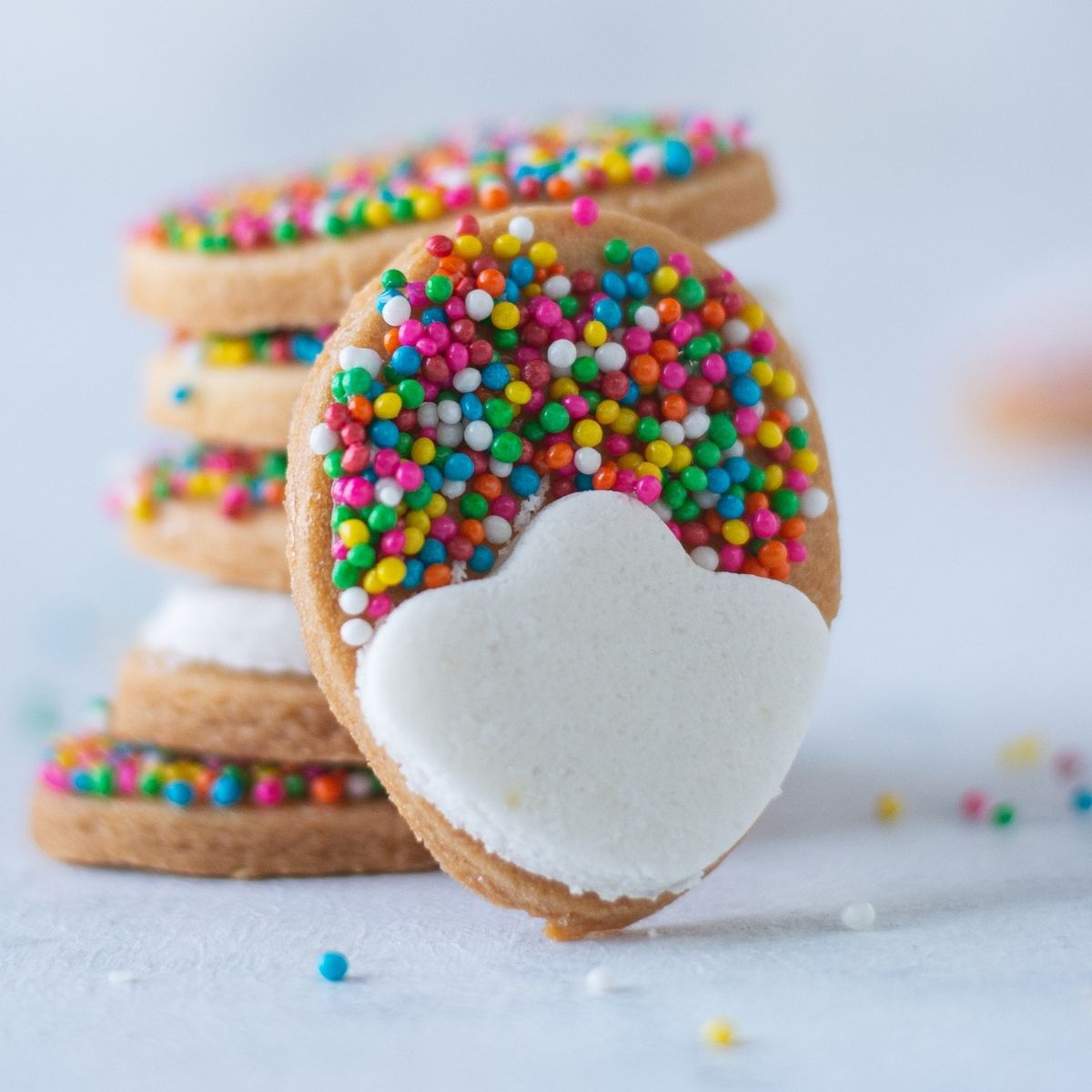 Easter egg shaped sugar cookies decorated with colorful icing and sprinkles.