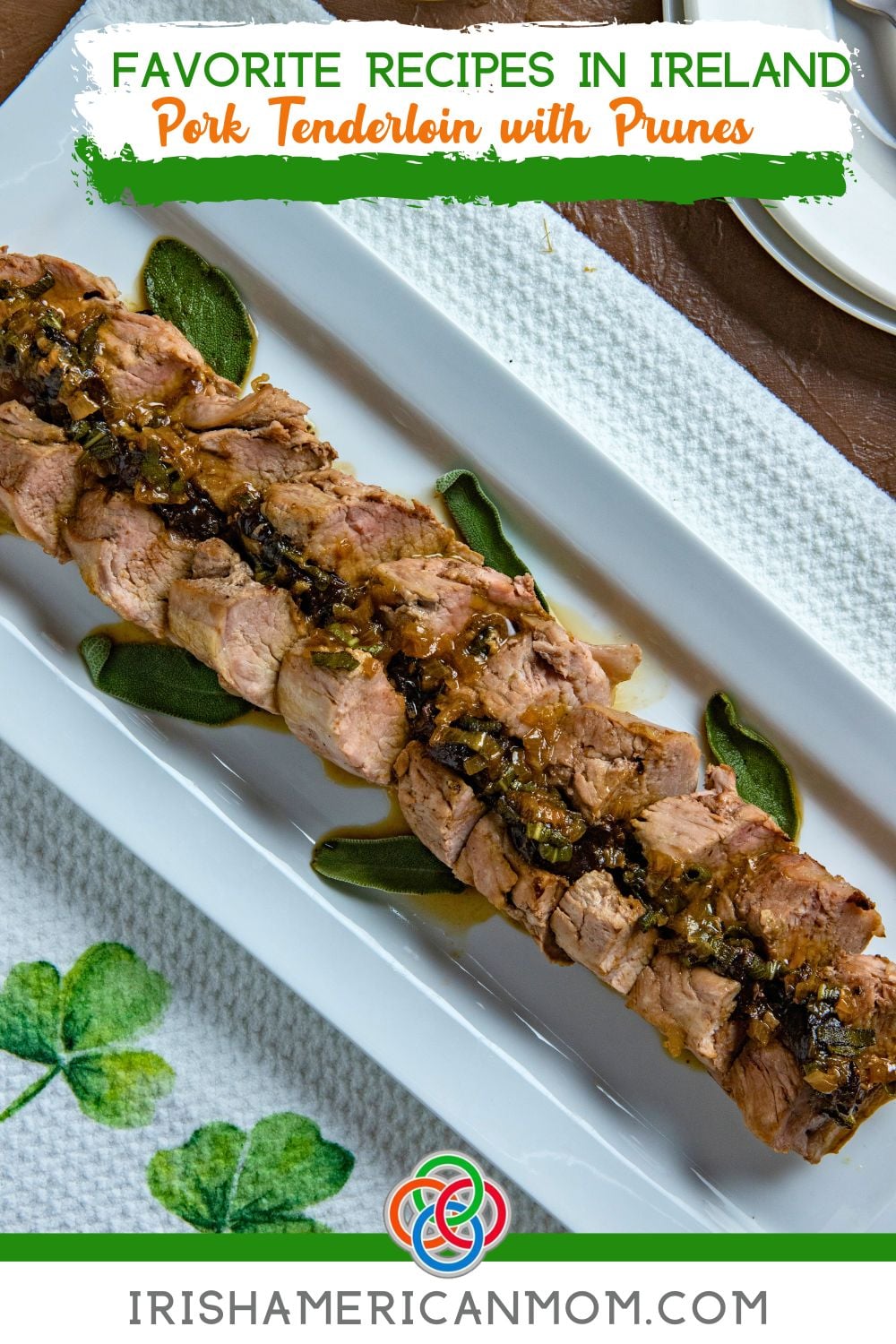 Sliced pork tenderloin stuffed with prunes and topped with shallot and sage gravy on a white serving platter.