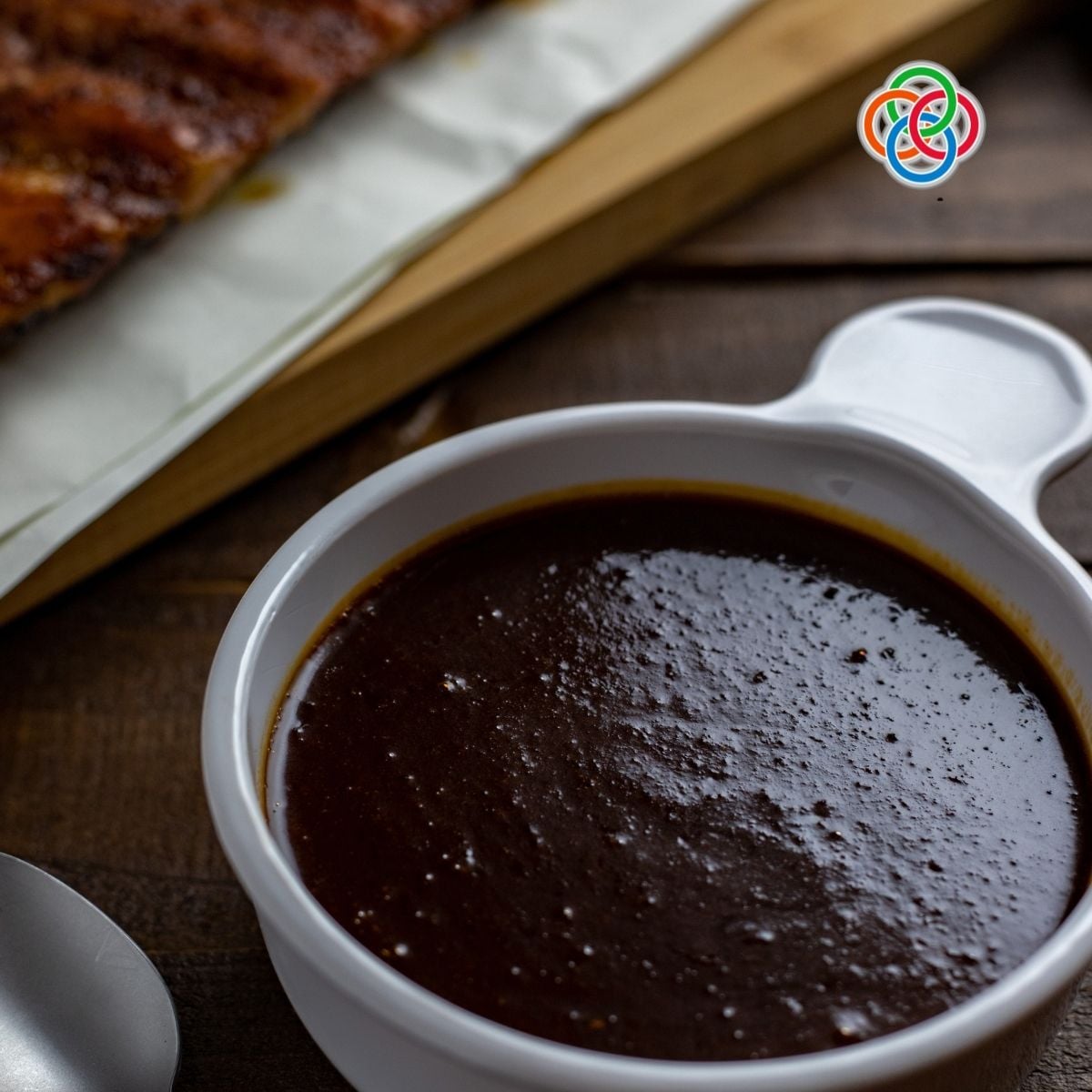 Ramekin of homemade Guinness barbecue sauce with a deep rich color
