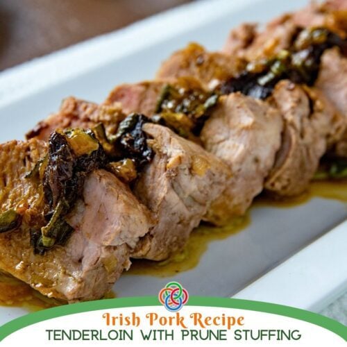 Close-up of sliced pork tenderloin with prune stuffing and gravy, labeled Irish pork recipe tenderloin with prune stuffing.