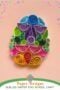Colorful quilled Easter egg made with paper coils and shapes on a soft background with decorative Easter eggs, with text reading “Paper Designs Quilled Easter Egg School Craft.”