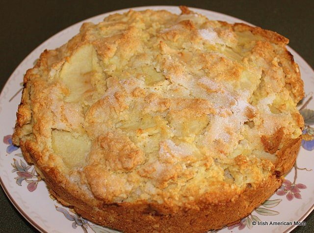 Traditional Irish apple cake with a golden crust and sliced apples inside.