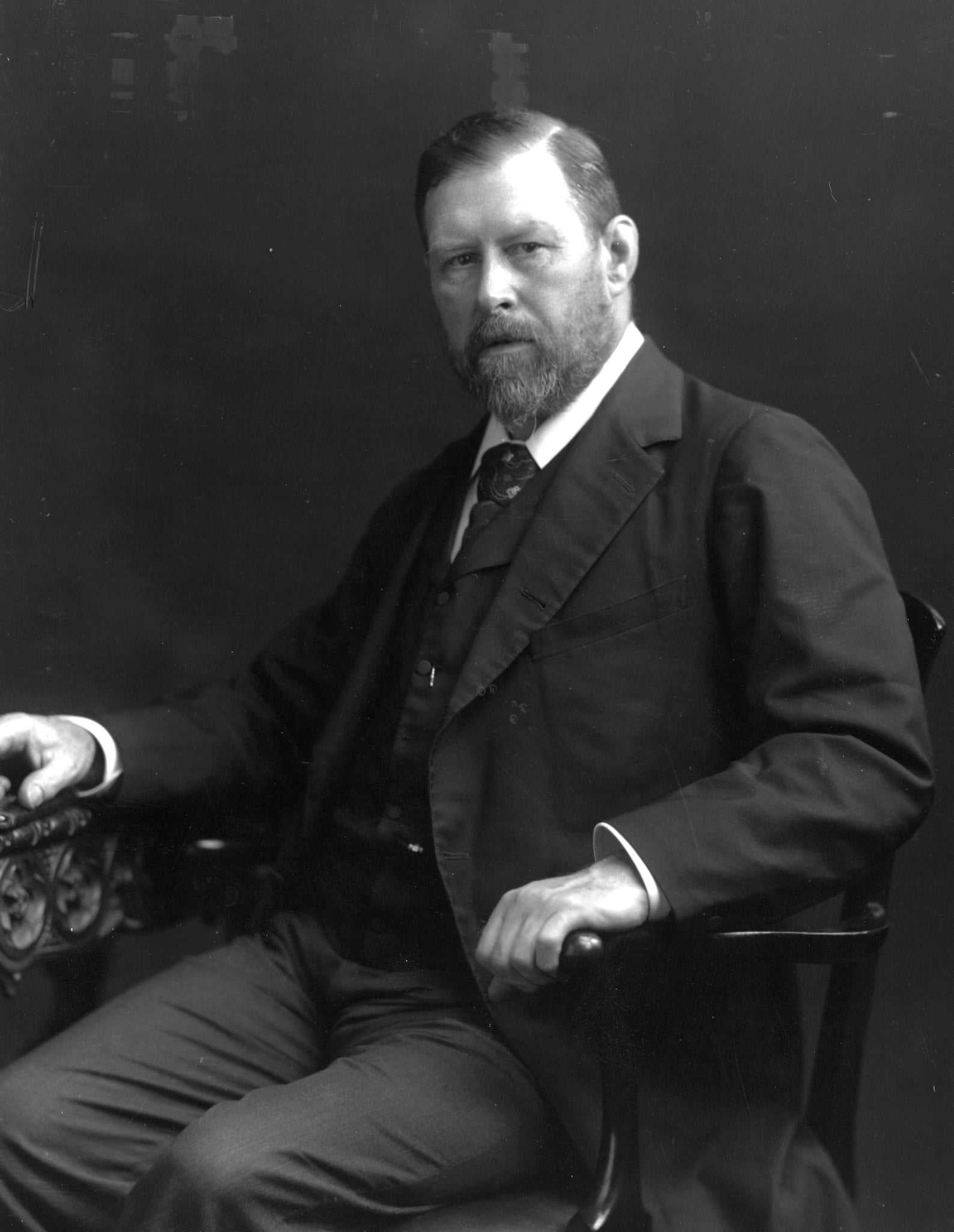 Black and white image of a seated bearded gentleman