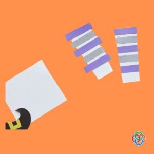 Creating striped witch legs for a Halloween Bookmark | Irish American Mom Purple and gray paper strips glued across white cardstock pieces to create striped witch stockings for a handmade Halloween witch bookmark.