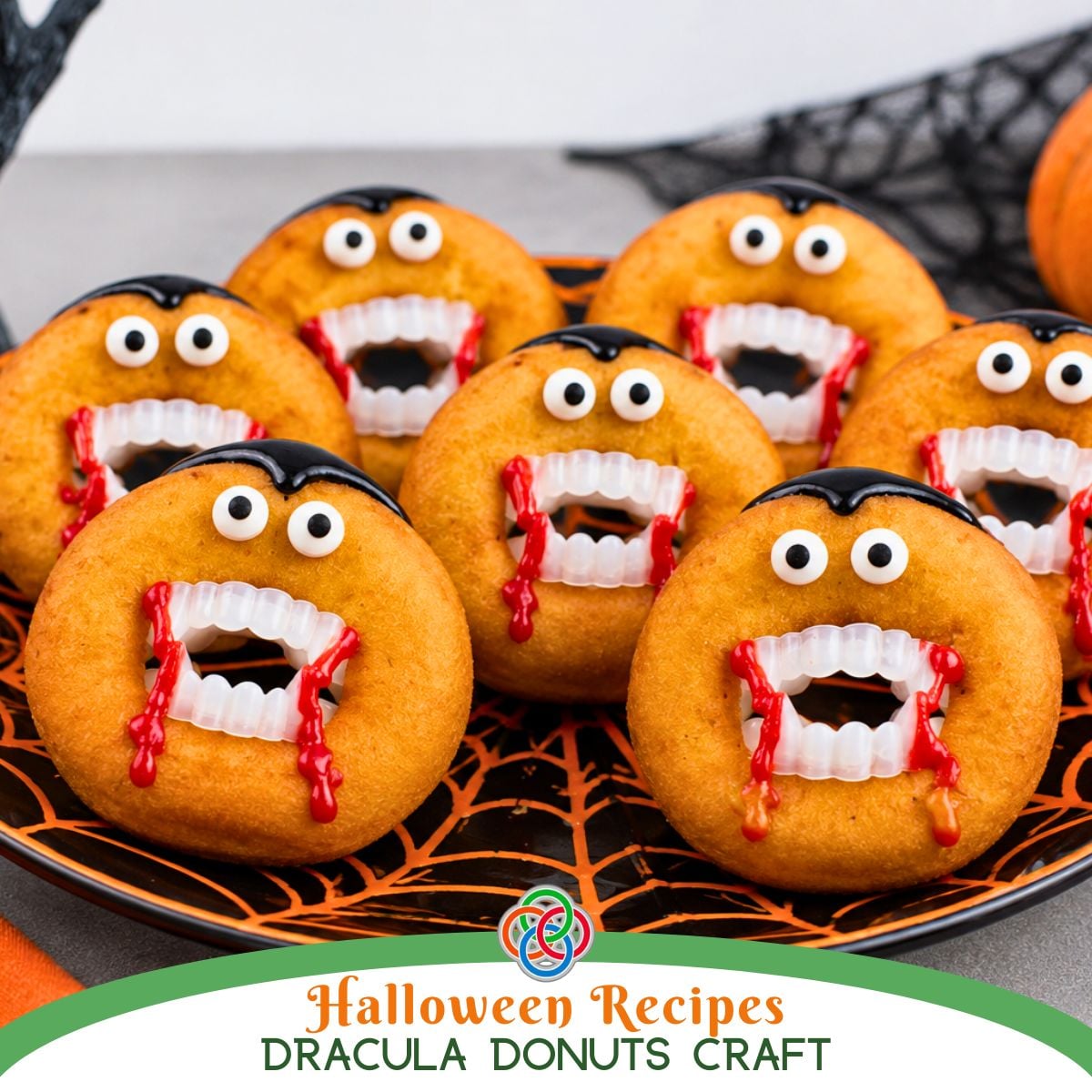 Halloween recipe graphic featuring Dracula donuts decorated with candy eyes, vampire fangs, black icing hair and dripping red icing on a black and orange spiderweb plate.