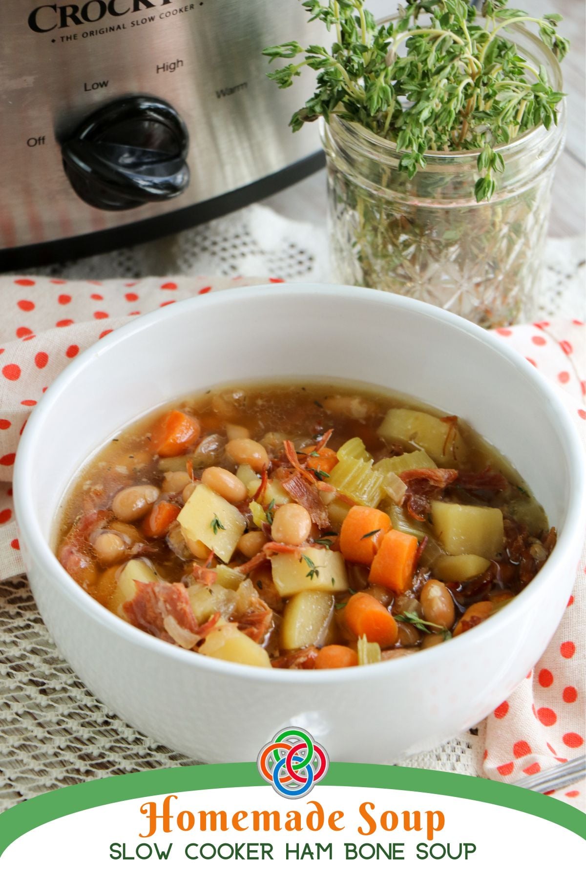 Homemade Soup Slow Cooker Ham Bone Soup | Irish American Mom Bowl of homemade slow cooker ham bone soup with shredded ham, potatoes, carrots, celery and white beans, pictured beside a Crock-Pot and fresh thyme