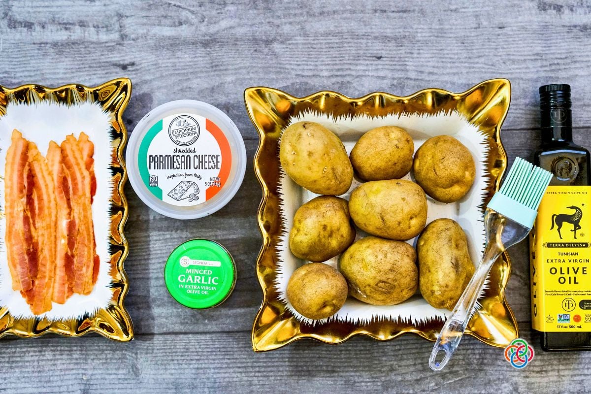 Ingredients for Roasted Bacon Parmesan Sheetpan Potatoes | Irish American Mom Ingredients for Bacon Parmesan Sheet Pan Potatoes including whole white potatoes, bacon, shredded Parmesan cheese, minced garlic and extra virgin olive oil.