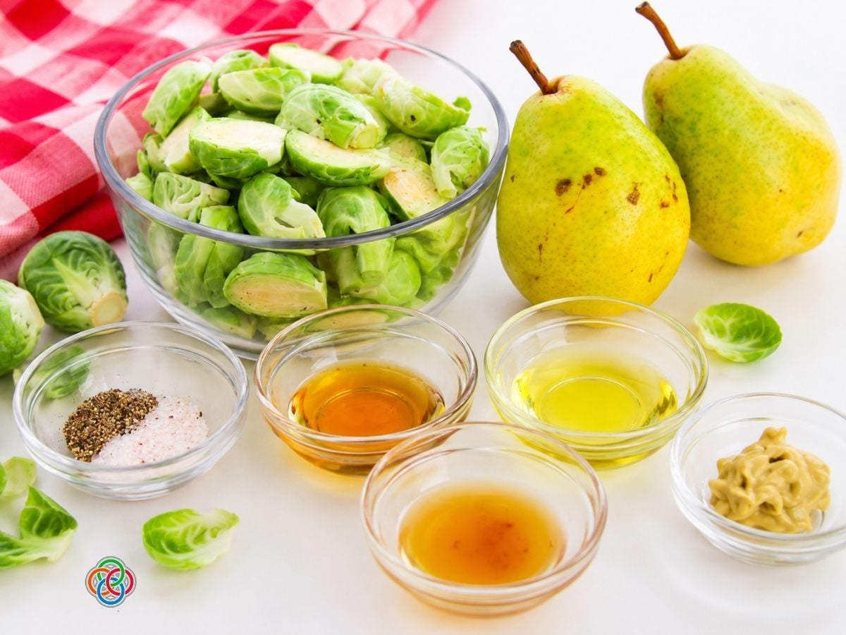Ingredients for maple dijon brussels sprouts and pears | Irish American Mom Ingredients for roasted Brussels sprouts and pears, including halved Brussels sprouts, fresh pears, olive oil, maple syrup, Dijon mustard, apple cider vinegar, salt and black pepper.