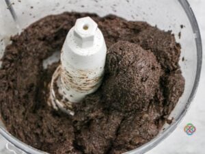 Forming Oreo and cream cheese balls in a food processor | Irish American Mom Chocolate cookie and cream cheese ball formed in a food processor