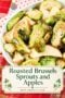 Pinterest recipe pin featuring a close-up of roasted Brussels sprouts with sliced apples and sweet onions in a white serving bowl on a red plaid tablecloth. A cream-colored title panel decorated with green shamrocks reads "Roasted Brussels Sprouts and Apples," with Irish American Mom branding underneath.